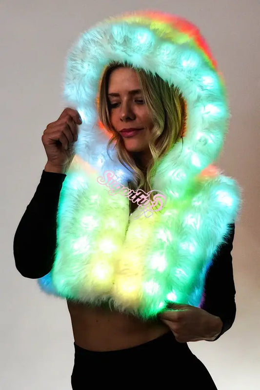 Light-up faux fur festival vest with multi-color LEDs activated. Model wearing the Aurora Halo vest glowing in the dark festival outfit.