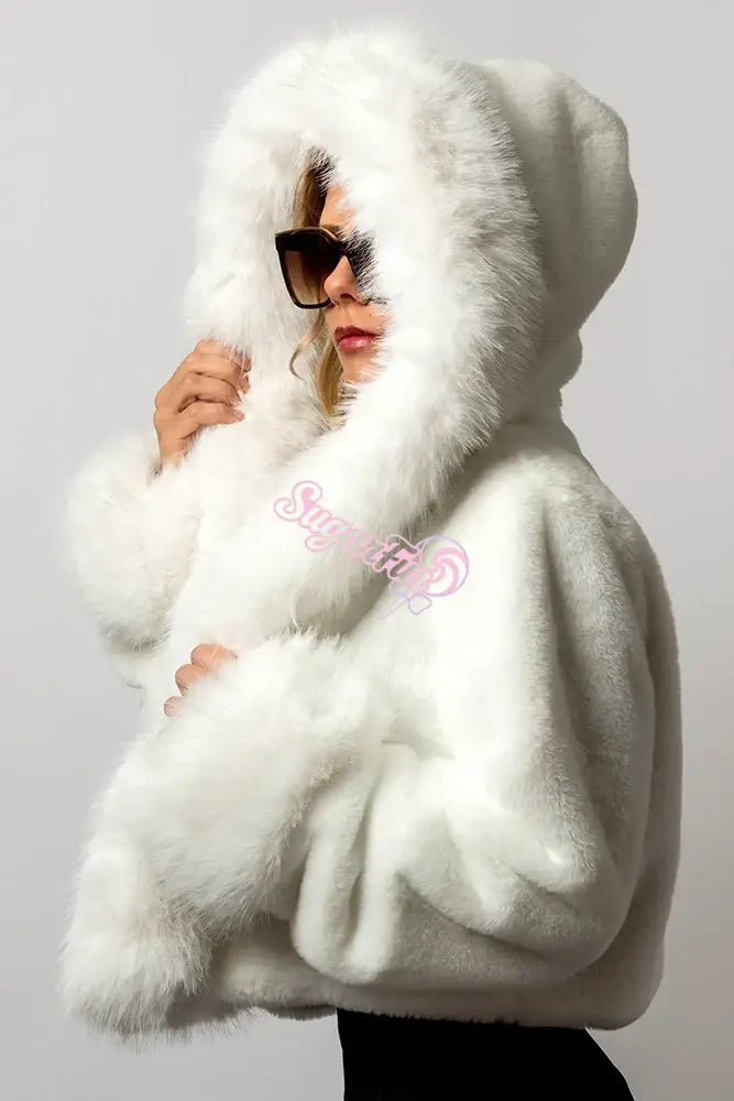 Side profile of SugarFur Candy Cloud Cropped LED Coat with the large white faux fur hood up.