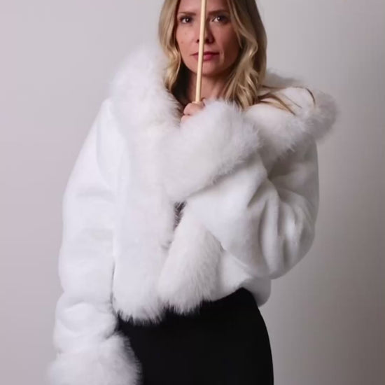 Woman spinning led parasol in studio showing flashing rainbow lights