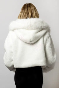 Back view of SugarFur Candy Cloud Cropped LED jacket that is a fluffy white cropped faux fur rave jacket for festival fashion, shown on a blonde model 