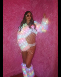 Light up fur coat and leg warmers on a model in front of pink fur