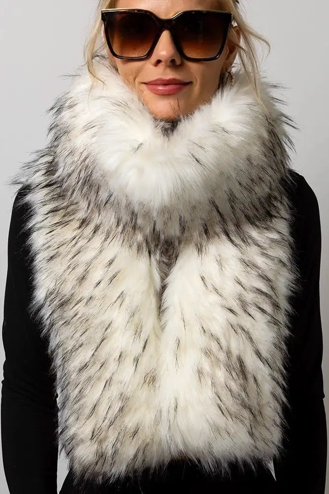 Woman wearing rainbow light up fur scarf around neck