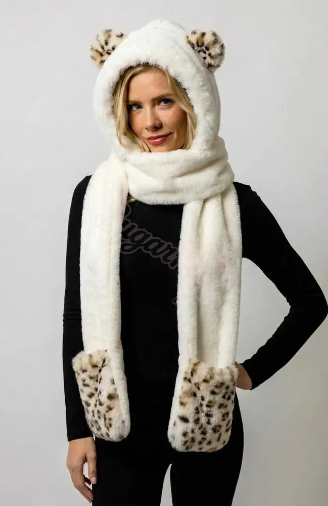 girl wearing a white scarf with leopard print ears on a plain background